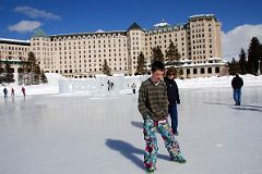 20 Peter Ryan And Charlotte Ryan On Frozen Lake Louise With Ice Castle And Chateau Lake Louise Behind In Winter.jpg